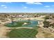 High-angle aerial view of the golf course, water features and lush greenery among residential properties at 16769 W Brookhaven Ct, Surprise, AZ 85387