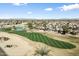 Panoramic aerial view of the golf course with a pond and sand traps, set among residential homes at 16769 W Brookhaven Ct, Surprise, AZ 85387