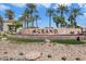 The Grand community sign with palm trees and desert landscaping in a beautiful setting at 16769 W Brookhaven Ct, Surprise, AZ 85387
