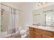 Bathroom featuring a shower-tub combo, vanity, large mirror, neutral colored walls, and tile flooring at 17017 N 12Th St # 2012, Phoenix, AZ 85022