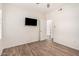 This bedroom has wood look tile flooring, a TV, ceiling fan, and a bright interior at 17017 N 12Th St # 2012, Phoenix, AZ 85022