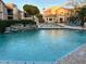 Large community pool surrounded by lounge chairs and lush landscaping at 17017 N 12Th St # 2012, Phoenix, AZ 85022