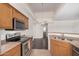 Spacious kitchen featuring stainless steel appliances, wooden cabinets, and dual sinks at 17017 N 12Th St # 2012, Phoenix, AZ 85022