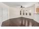 Spacious living area with dark hardwood floors, three shuttered windows, and ceiling fan at 17017 N 12Th St # 2012, Phoenix, AZ 85022