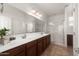 Bathroom with a double sink vanity, a large mirror, and a glass-enclosed shower at 18222 E La Posada Ct, Gold Canyon, AZ 85118