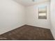 Clean bedroom featuring neutral carpet, white walls, baseboard, and bright natural light at 18222 E La Posada Ct, Gold Canyon, AZ 85118