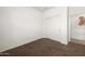 Empty bedroom featuring neutral colored carpet, a closet, and an entrance to another room at 18222 E La Posada Ct, Gold Canyon, AZ 85118