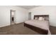Comfortable bedroom with a soft carpet and a view into an attached bathroom at 18222 E La Posada Ct, Gold Canyon, AZ 85118