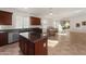 Open-concept kitchen with granite counters, stainless appliances, and tile flooring that flows into the living area at 18222 E La Posada Ct, Gold Canyon, AZ 85118