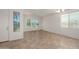 Bright living room with neutral tile flooring and lots of natural light from several windows at 18222 E La Posada Ct, Gold Canyon, AZ 85118