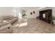 Living room with tile floors, sliding glass doors to the backyard, and an entertainment center at 18222 E La Posada Ct, Gold Canyon, AZ 85118