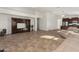Spacious living room with a built-in entertainment center, tile flooring, and ample natural light at 18222 E La Posada Ct, Gold Canyon, AZ 85118