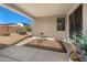 Covered patio area with desert landscaping with a small table and chairs set at 18222 E La Posada Ct, Gold Canyon, AZ 85118