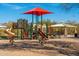 Neighborhood playground with colorful equipment and covered picnic area at 18222 E La Posada Ct, Gold Canyon, AZ 85118