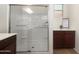 Walk-in shower with glass door and tiled walls, accompanied by a vanity and storage cabinet at 18222 E La Posada Ct, Gold Canyon, AZ 85118