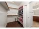 Walk-in closet with shelving for pillows, and an entrance to an ensuite bathroom at 18222 E La Posada Ct, Gold Canyon, AZ 85118