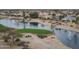 Aerial view features the community's serene lake, lush landscaping, and attractive residential architecture at 19615 N Sunburst Way, Surprise, AZ 85374