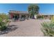 Expansive backyard featuring a covered patio and well-maintained desert landscaping, offering outdoor enjoyment at 19615 N Sunburst Way, Surprise, AZ 85374