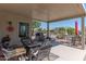 Spacious covered patio with comfortable seating, perfect for outdoor entertaining and relaxation at 19615 N Sunburst Way, Surprise, AZ 85374