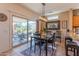 Bright dining area featuring a modern light fixture and sliding glass doors to the outdoor patio at 19615 N Sunburst Way, Surprise, AZ 85374