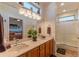 Bright main bathroom featuring double sinks, updated fixtures, and a walk-in shower at 19615 N Sunburst Way, Surprise, AZ 85374
