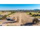 Sprawling property showcasing a home and expansive land, set against scenic mountain views and clear blue skies at 20521 E Germann Rd, Queen Creek, AZ 85142
