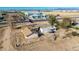Overview of a house with a fenced area, next to a vacant lot; a fixer upper at 20521 E Germann Rd, Queen Creek, AZ 85142