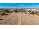 Wide aerial view of land near commercial establishments and roadways, showcasing development potential at 20521 E Germann Rd, Queen Creek, AZ 85142