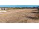 Expansive field ready for development, showcasing potential with distant horizon and clear skies at 20521 E Germann Rd, Queen Creek, AZ 85142