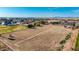 Expansive land with scattered vegetation and some homes visible in the distance at 20521 E Germann Rd, Queen Creek, AZ 85142