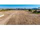 Vast, flat land awaiting development, bordered by greenery and hints of a nearby neighborhood at 20521 E Germann Rd, Queen Creek, AZ 85142