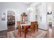 Charming dining area with hardwood floors and a display cabinet for elegant storage at 20540 N 86Th Ln, Peoria, AZ 85382