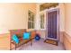Inviting front porch with a metal bench with blue pillows and plants near front door at 20540 N 86Th Ln, Peoria, AZ 85382