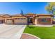 Attractive single-story home featuring a basketball hoop, paver patio, and a well-maintained front yard at 20540 N 86Th Ln, Peoria, AZ 85382