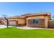 View of the garage and the side entrance, with artificial turf in front of the home at 20540 N 86Th Ln, Peoria, AZ 85382