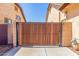 Side gate, constructed of horizontal planks, provides privacy between houses at 20540 N 86Th Ln, Peoria, AZ 85382