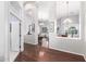 Open-concept living and dining areas featuring dark wood floors and elegant chandeliers at 20540 N 86Th Ln, Peoria, AZ 85382