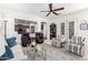 Bright living room with tile floors, ceiling fan, open floor plan, and plenty of seating at 20540 N 86Th Ln, Peoria, AZ 85382