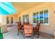 Inviting patio with ample seating under a sunshade, perfect for outdoor dining and relaxation at 20540 N 86Th Ln, Peoria, AZ 85382