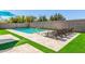 Resort-style pool with Baja step, lounge seating and artificial turf at 20540 N 86Th Ln, Peoria, AZ 85382