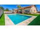Backyard showcasing a sparkling pool, with outdoor seating and manicured landscaping at 20540 N 86Th Ln, Peoria, AZ 85382