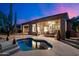 Backyard view featuring a freeform pool and spa, covered patio, and a towering Saguaro cactus at 20933 N 70Th Dr, Glendale, AZ 85308