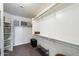 Bright walk-in closet featuring custom shelving, ample storage, and plush carpeting at 20933 N 70Th Dr, Glendale, AZ 85308