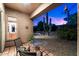 Relaxing covered patio seating area overlooking the pool and desert landscaping at 20933 N 70Th Dr, Glendale, AZ 85308
