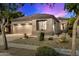 Charming single-story home featuring a desert landscape, a two-car garage, and a neutral color palette at 20933 N 70Th Dr, Glendale, AZ 85308