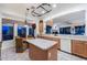Well-lit kitchen with ample counter space, a kitchen island, and a dining area for casual meals at 20933 N 70Th Dr, Glendale, AZ 85308