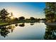 Beautiful lake view featuring a fountain, green landscaping, and a tranquil waterfront at 20933 N 70Th Dr, Glendale, AZ 85308