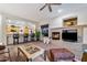 Spacious living area with fireplace, kitchen access, and open design for entertaining at 20933 N 70Th Dr, Glendale, AZ 85308