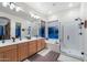 Bright main bathroom features double vanity, soaking tub, glass shower, and large windows at 20933 N 70Th Dr, Glendale, AZ 85308