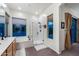 Spacious main bathroom featuring a glass shower and soaking tub with picturesque backyard views at 20933 N 70Th Dr, Glendale, AZ 85308